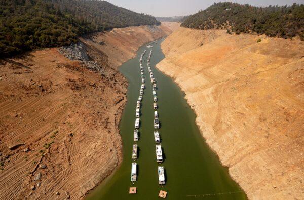 Houseboats sit in a narrow section of water in a depleted Lake Oroville in Oroville, Calif., on Sept. 5, 2021. (Josh Edelson/AFP via Getty Images)