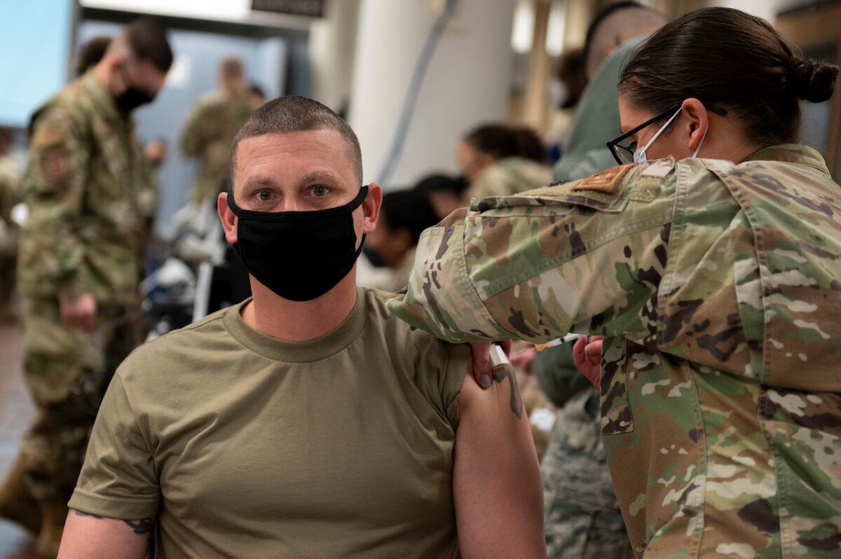 A U.S. Air Force member receives a COVID-19 vaccine at Osan Air Base, Republic of Korea, on Dec. 29, 2020. (U.S. Air Force photo by Staff Sgt. Betty R. Chevalier via Getty Images)