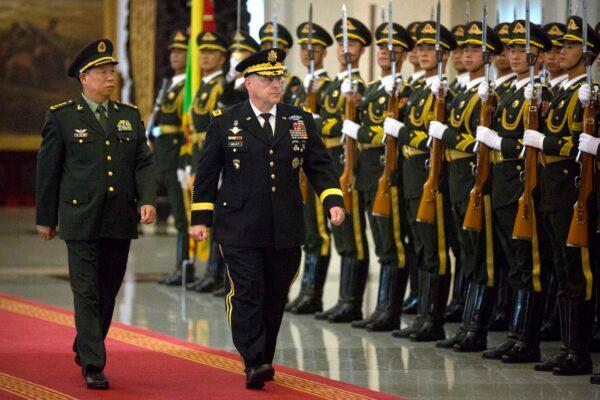 China's People's Liberation Army (PLA) General Li Zuocheng (L) and Army Chief of Staff General Mark Milley (C) review an honor guard during a welcome ceremony at the Bayi Building in Beijing on Aug. 16, 2016. (Mark Schiefelbein/AFP via Getty Images)