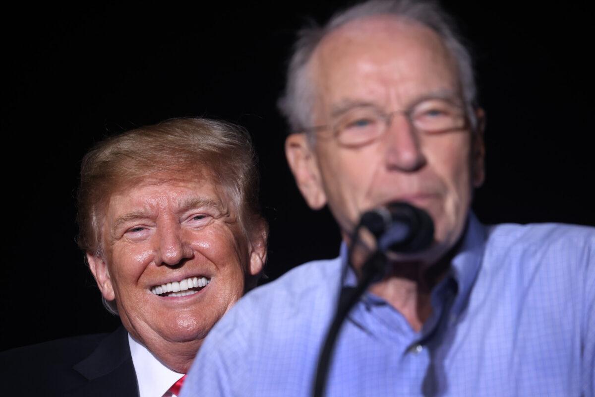 Former President Donald Trump smiles as Sen. Chuck Grassley (R-Iowa) speaks during a rally at the Iowa State Fairgrounds in Des Moines, Iowa, on Oct. 9, 2021. (Scott Olson/Getty Images)