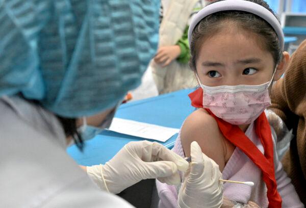 After the city began vaccinating children between the ages of 3 and 11, this child was pictured receiving the COVID-19 coronavirus vaccine at a school in Handan in China's northern Hebei province, on Oct. 27, 2021. (AFP via Getty Images)
