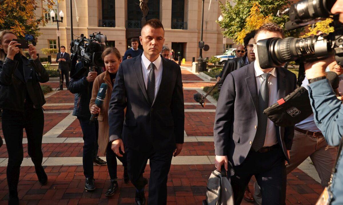 Russian analyst Igor Danchenko is pursued by journalists as he departs the Albert V. Bryan U.S. Courthouse after being arraigned, in Alexandria, Va., on Nov. 10, 2021. (Chip Somodevilla/Getty Images)