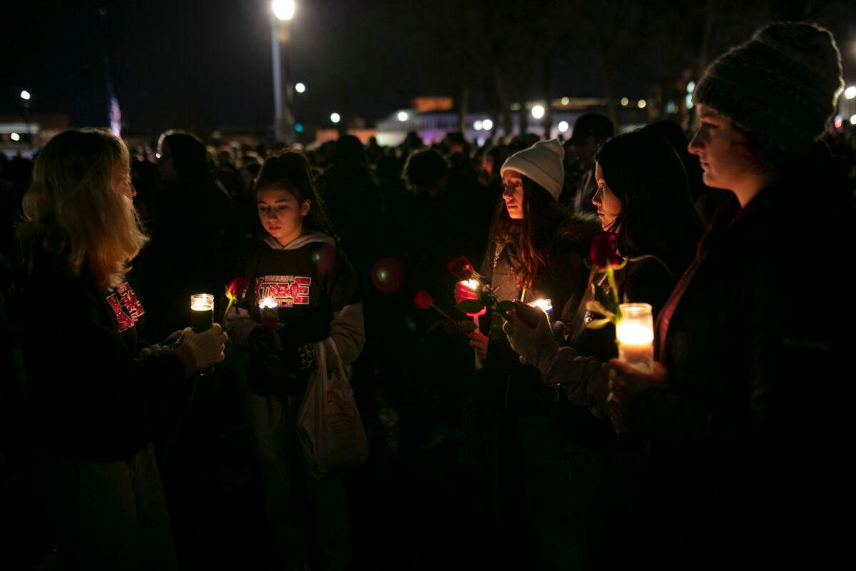 People hold candles during a vigil in Cutler Park in Waukesha, Wis., on Nov. 22, 2021. (Jim Vondruska/Getty Images)