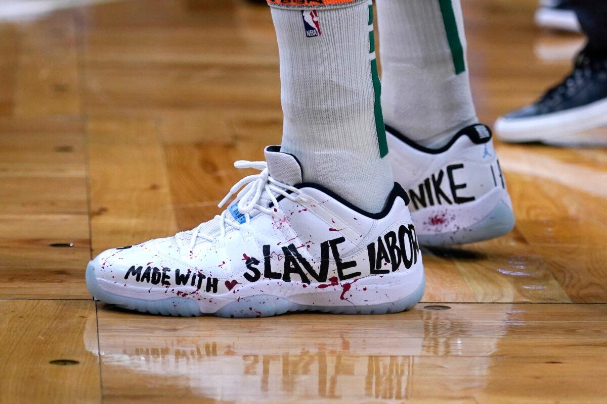 Boston Celtics center Enes Kanter Freedom wears basketball shoes bearing his political message during the first half of an NBA basketball game, in Boston, on Dec. 1, 2021. (Charles Krupa/AP Photo)
