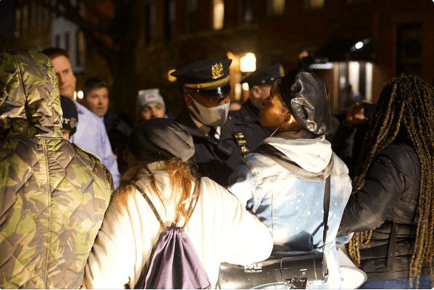 Police getting protesters out of the road outside Bill de Blasio's residence in Brooklyn, New York, on Dec. 8, 2021. (Enrico Trigoso/The Epoch Times)
