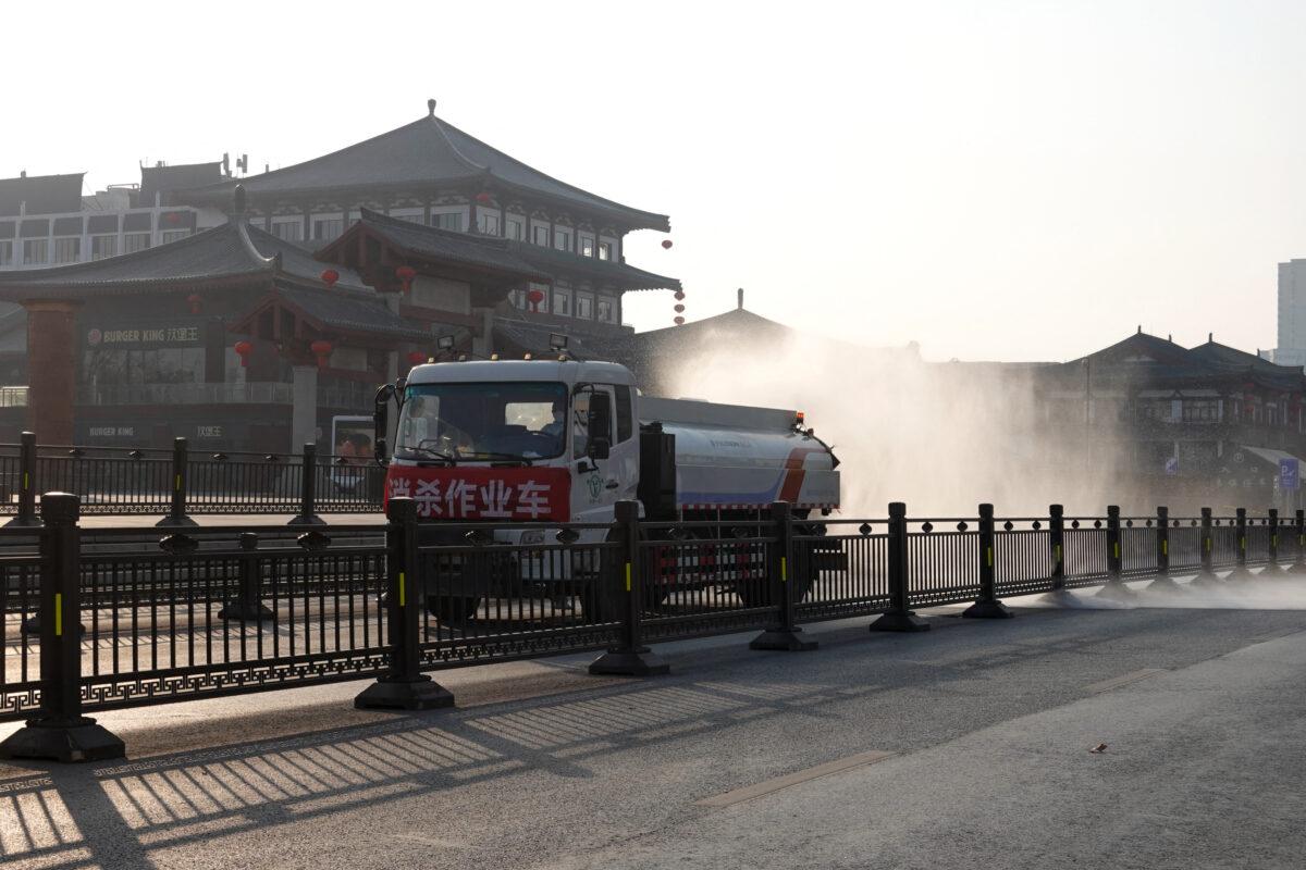 A truck sprays disinfectant on the street in Xi'an in China's Shaanxi Province, amid a COVID-19 lockdown, on Dec. 31, 2021. - China OUT (STR/AFP via Getty Images)
