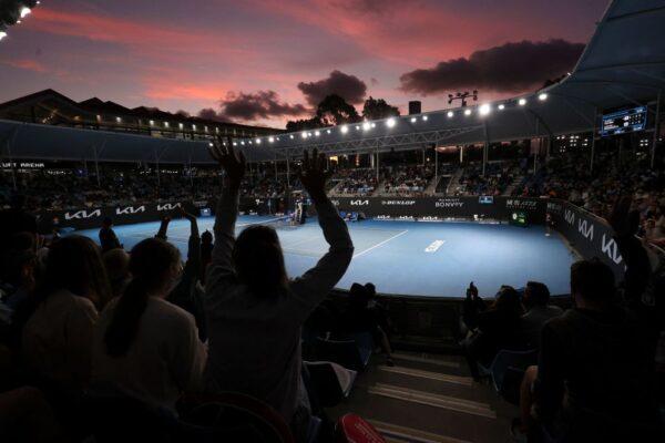 The sun sets as spectators wait for the men's singles match on day two of the Australian Open tennis tournament in Melbourne, Australia, on Jan. 18, 2022. (Martin Keep/AFP via Getty Images)