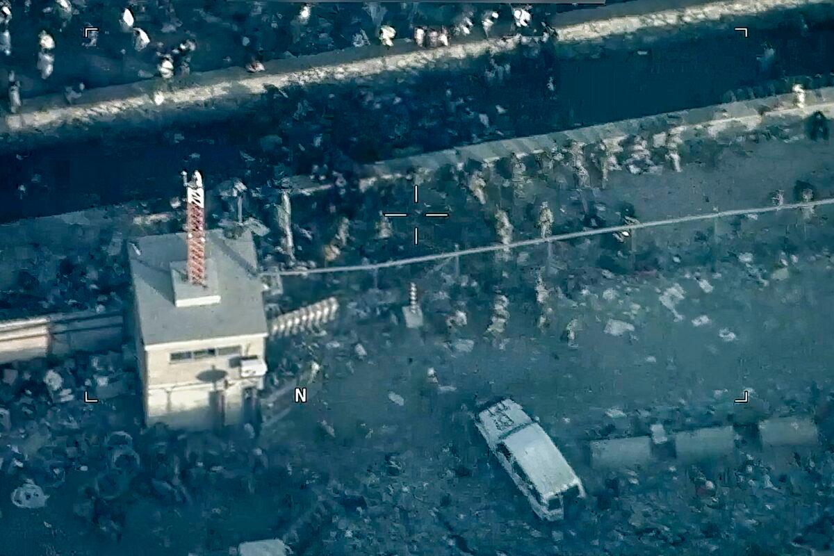 U.S. Marines secure Abbey Gate after a suicide bomber detonated an explosion, outside Hamid Karzai International Airport in Kabul, Afghanistan, on Aug. 15, 2021, leaving 12 U.S. servicemembers and more than 170 Afghanis dead. (Department of Defense via AP)