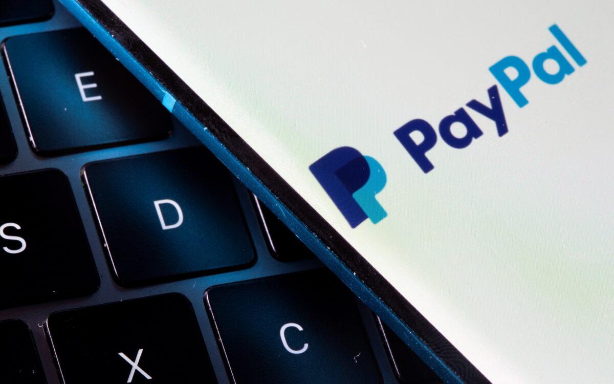 A smartphone with the PayPal logo is placed on a laptop in this illustration taken on July 14, 2021. (Dado Ruvic/Illustration/Reuters)