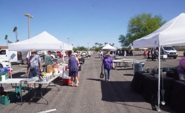 Customers browse among the farm stands at Sun City Farmers' Market in Sun City, Ariz., on April 7, 2022. (Allan Stein/The Epoch Times)