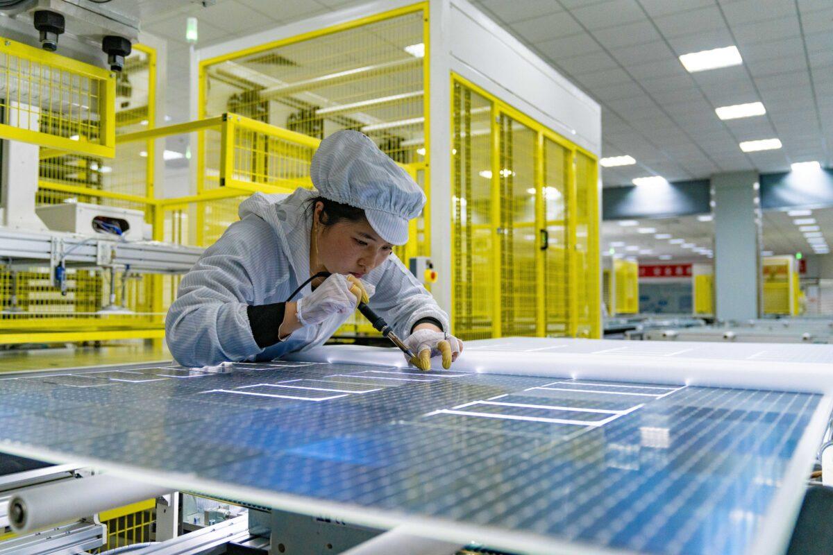 An employee works on the production line of solar panels for orders from India at a factory of GCL (Group) Holding Co., Ltd in Hefei, Anhui Province of China, on Jan. 5, 2022. (Ruan Xuefeng/VCG via Getty Images)