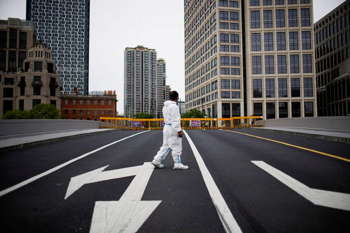 A worker in a protective suit walks on a closed bridge during the lockdown in Shanghai, China, on May 18, 2022. (Aly Song/File Photo/Reuters)