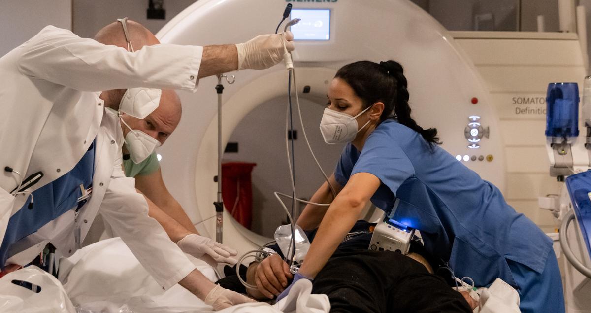 Medical staff prepare a patient for a CT scan at the main city hospital in Innsbruck, Austria, on Jan. 1, 2022. (Jan Hetfleisch/Getty Images)