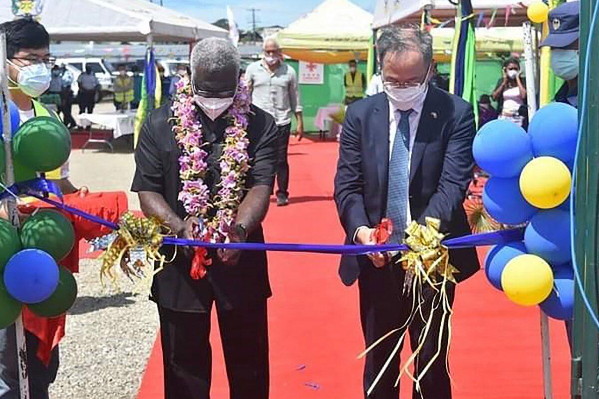 China's ambassador to the Solomon Islands Li Ming (R), and Solomons Prime Pinister Manasseh Sogavare are cutting a ribbon during the opening ceremony of a China-funded national stadium complex in Honiara on April 22, 2022. (Mavis Podokolo/AFP via Getty Images)