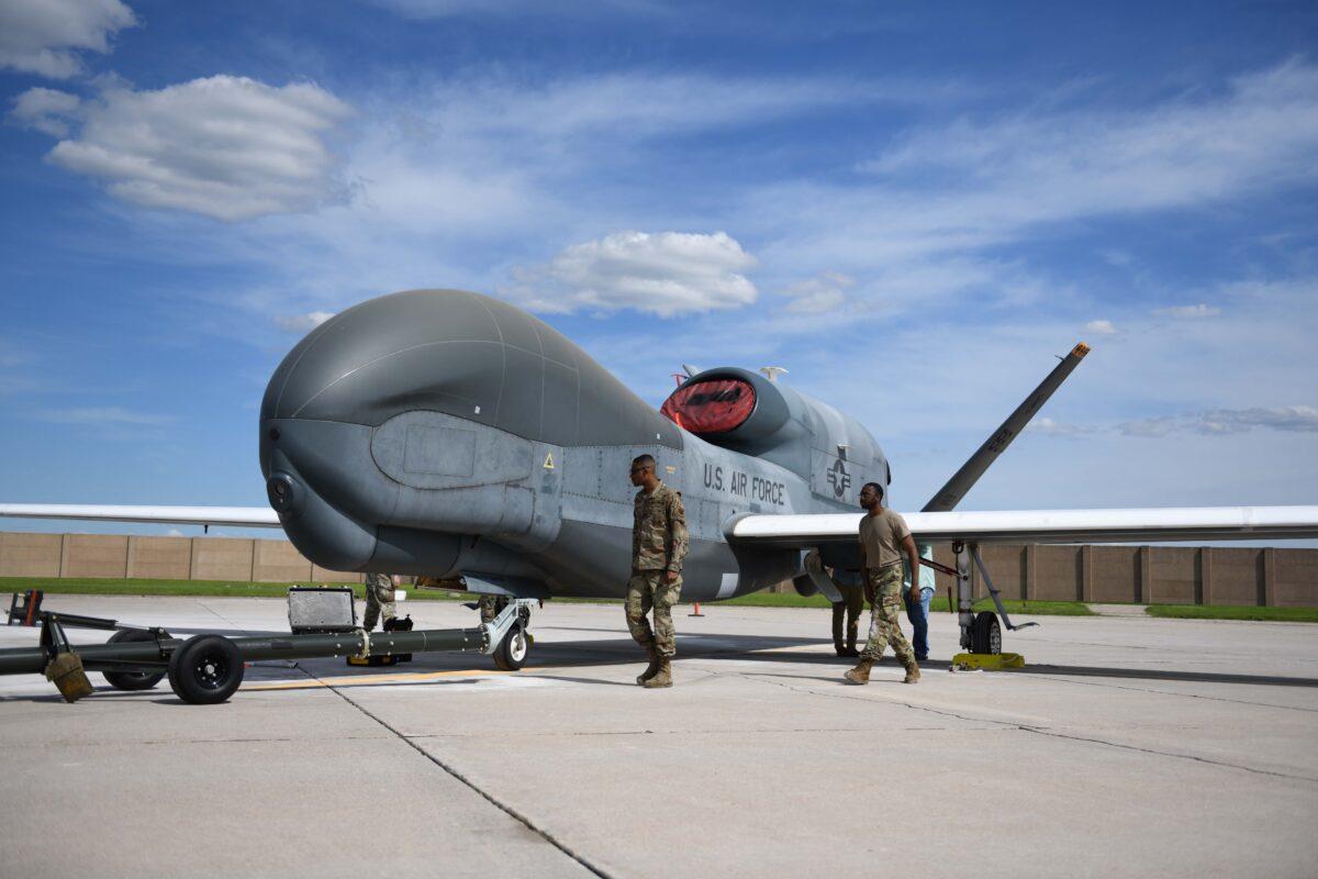 Airmen assigned to the 319th Aircraft Maintenance Squadron from Grand Forks Air Force Base perform a maintenance check on a drone, in North Dakota, on June 6, 2022. (U.S. Air Force photo by Senior Airman Ashley Richards)