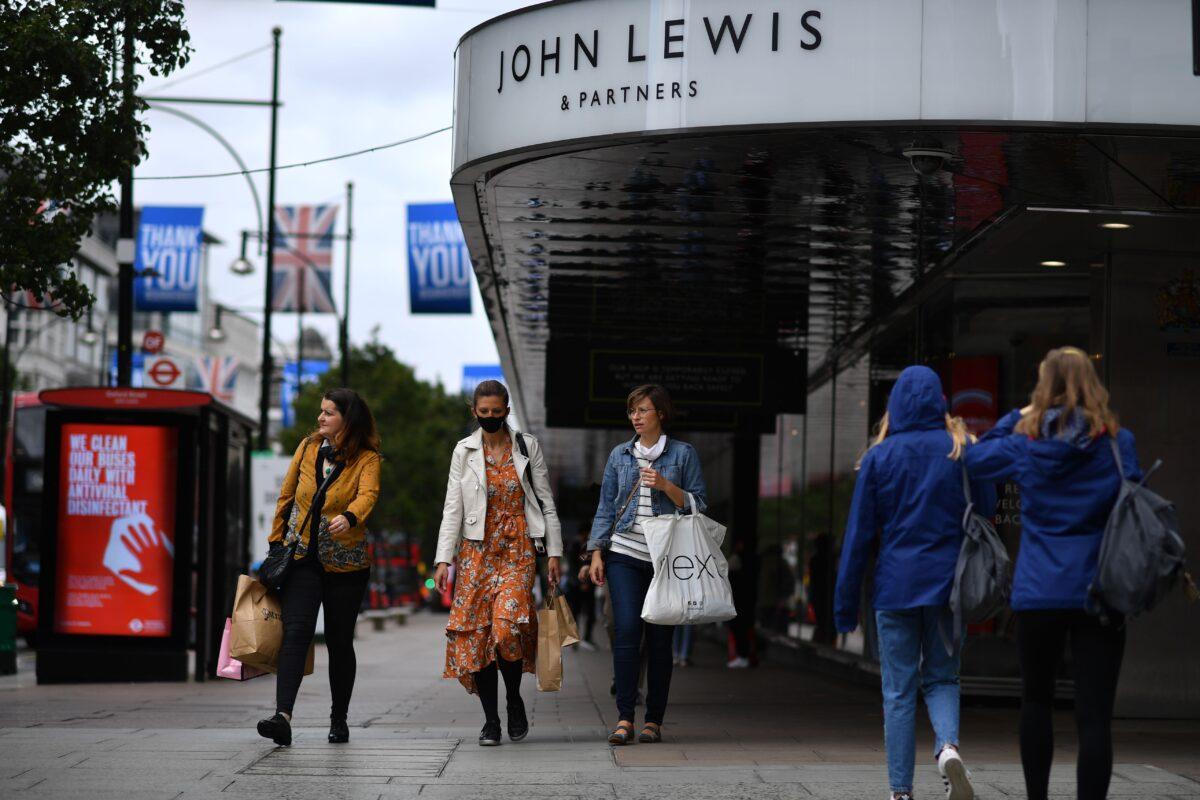 Shoppers walk past a John Lewis store in Oxford Street, central London on July 2, 2020. (Ben Stansall/AFP via Getty Images)