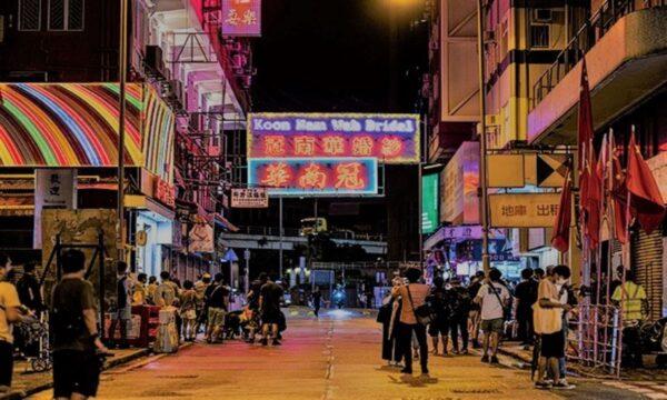On the last light of the display of the neon signs of the long-established shop "Koon Nam Wah" in Yau Ma Tei, people came to take pictures of the scene at 10:30 p.m. on Aug. 16, 2022. (TM Chan/The Epoch Times)