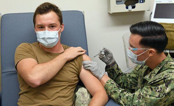 A hospital corpsman administers a COVID-19 vaccine to a fellow corpsman at Naval Health Clinic Hawaii on Dec. 16, 2020. (Courtesy of Naval Health Clinic Hawaii)