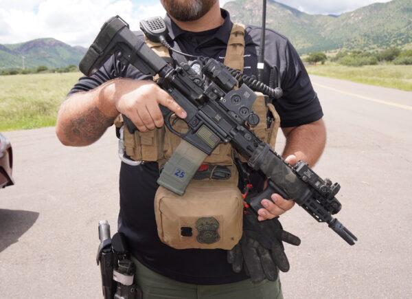 Kyle, a private security professional, carries an AR-15 semiautomatic rifle as personal protection before entering a known "hot spot" for human trafficking in the Coronado National Forest in southern Arizona. (Allan Stein/The Epoch Times)