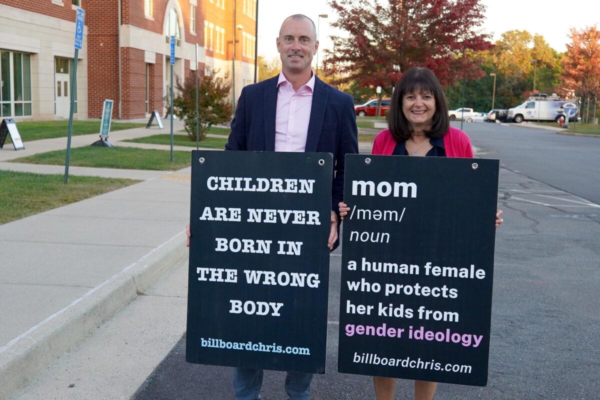 Chris Elston (L), also known as Billboard Chris, outside the Loudoun County Public School's administration building in Ashburn, Va., on Oct. 11, 2022. (Terri Wu/The Epoch Times)