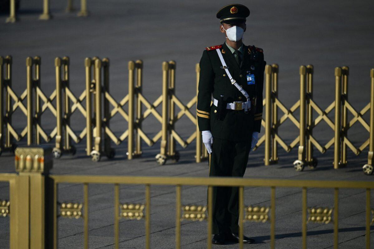 A security member keeps watch on Tiananmen Square, ahead of the opening session of a five-year Chinese Communist Party political conference in Beijing on Oct. 16, 2022. (Noel Celis/AFP via Getty Images)