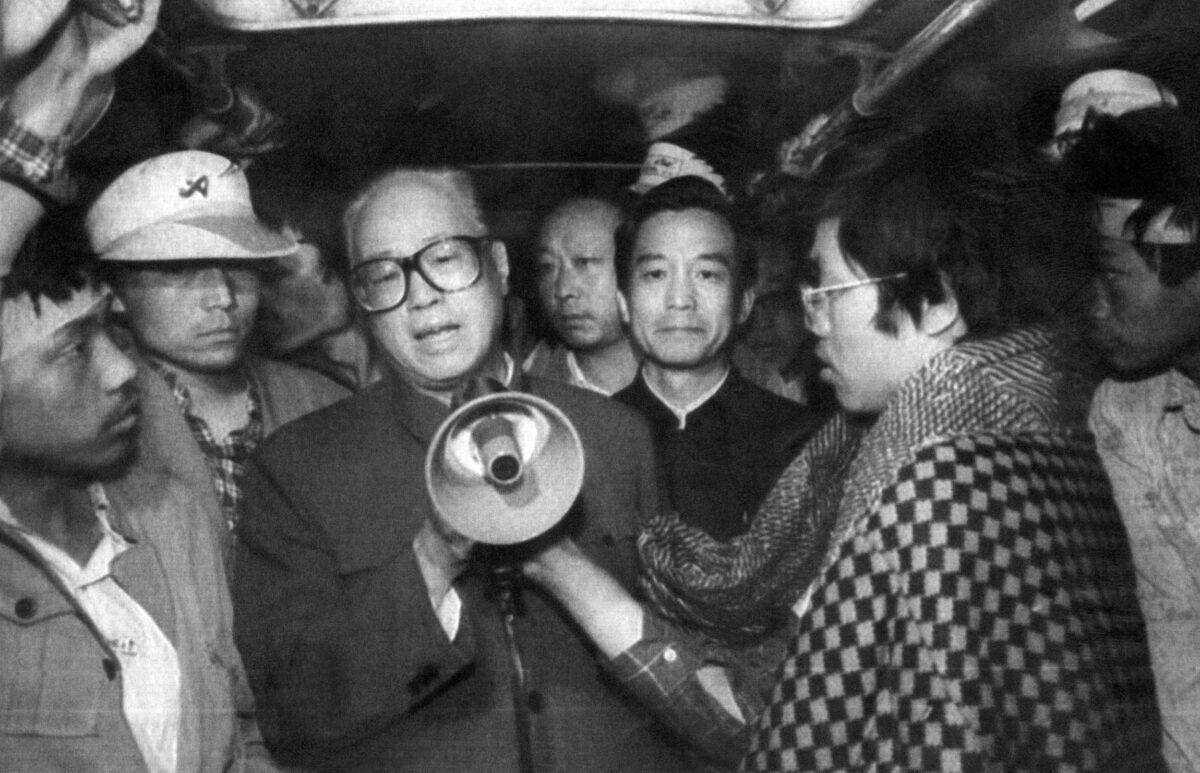 Chinese Communist Party (CCP) General Secretary Zhao Ziyang (C) addresses the student hunger strikers through a megaphone at dawn in one of the buses where pro-democracy hunger strikers had been sheltered, at Tiananmen Square in Beijing on 19 May 1989. (XINHUA/AFP via Getty Images)