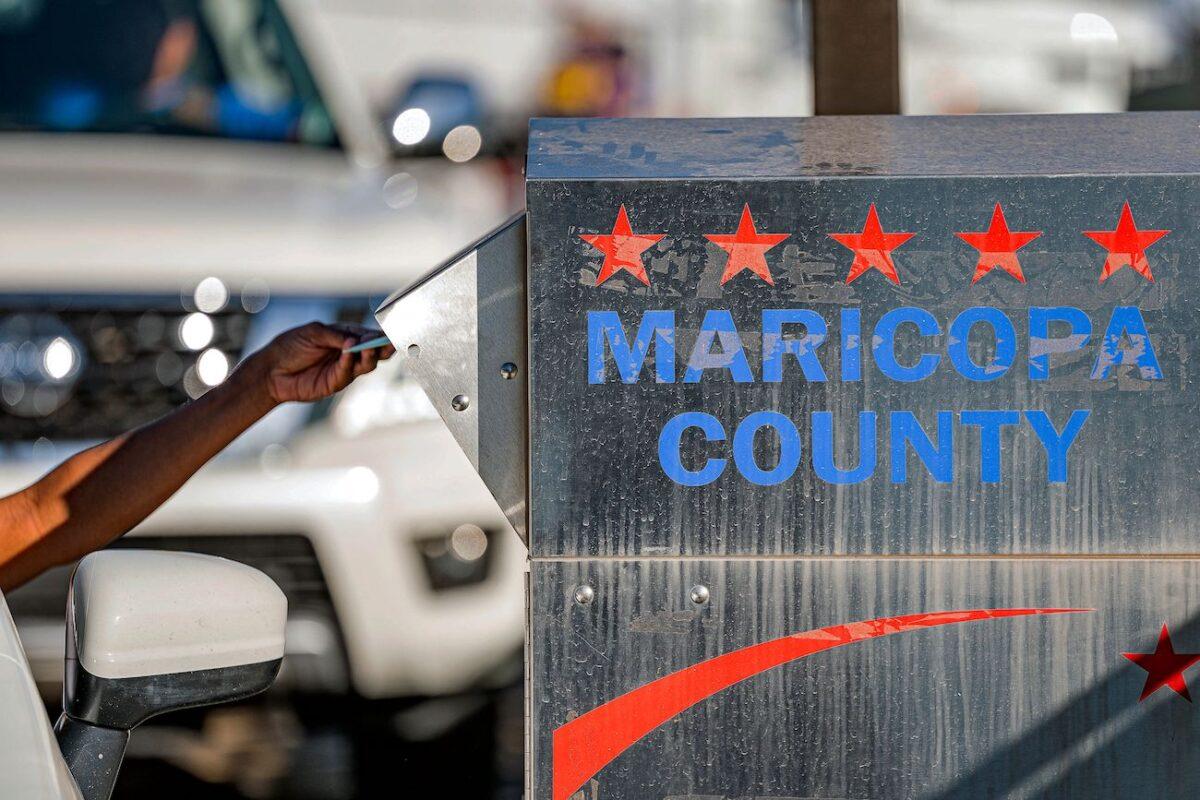 Voters drop their ballot in a dropbox in the U.S. midterm election at the Maricopa County Tabulation and Election Center, in Phoenix, Ariz., on Nov. 8, 2022. (Olivier Touron/AFP via Getty Images)