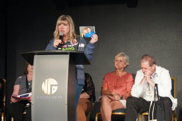 During a press conference on Oct. 13, 2022, in Kissimmee, Fla., widow Patty Myers holds a picture of her husband who died while being treated at a hospital for COVID-19. She's made a documentary called "Making a Killing" to raise awareness. (Nanette Holt/The Epoch Times)
