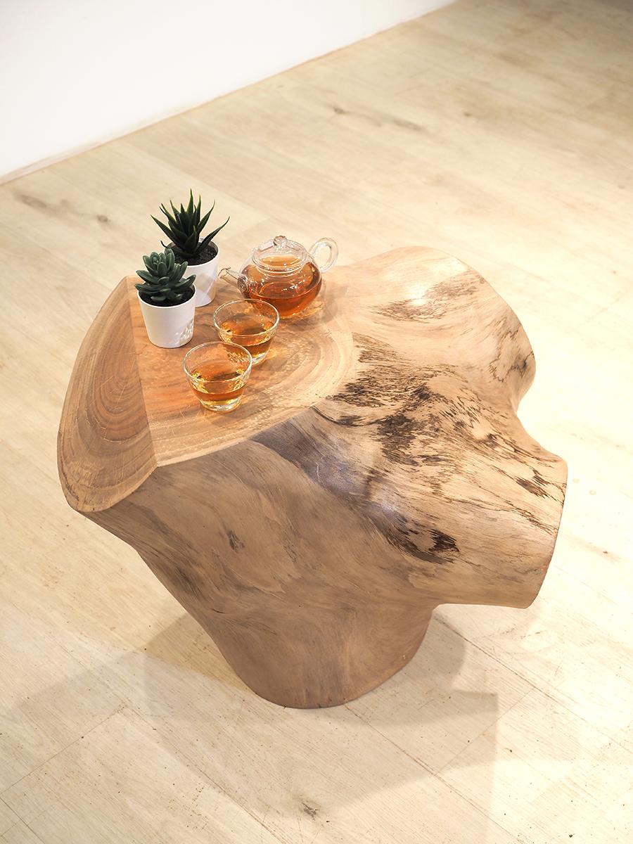 A coffee table made from a portion of wood from the trunk of a tree. (Courtesy of Ricci Wong)