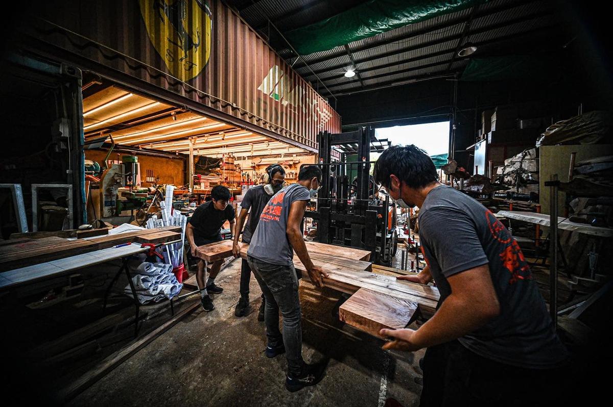 Moving slabs of wood into place takes teamwork and effort. (Courtesy of Ricci Wong)