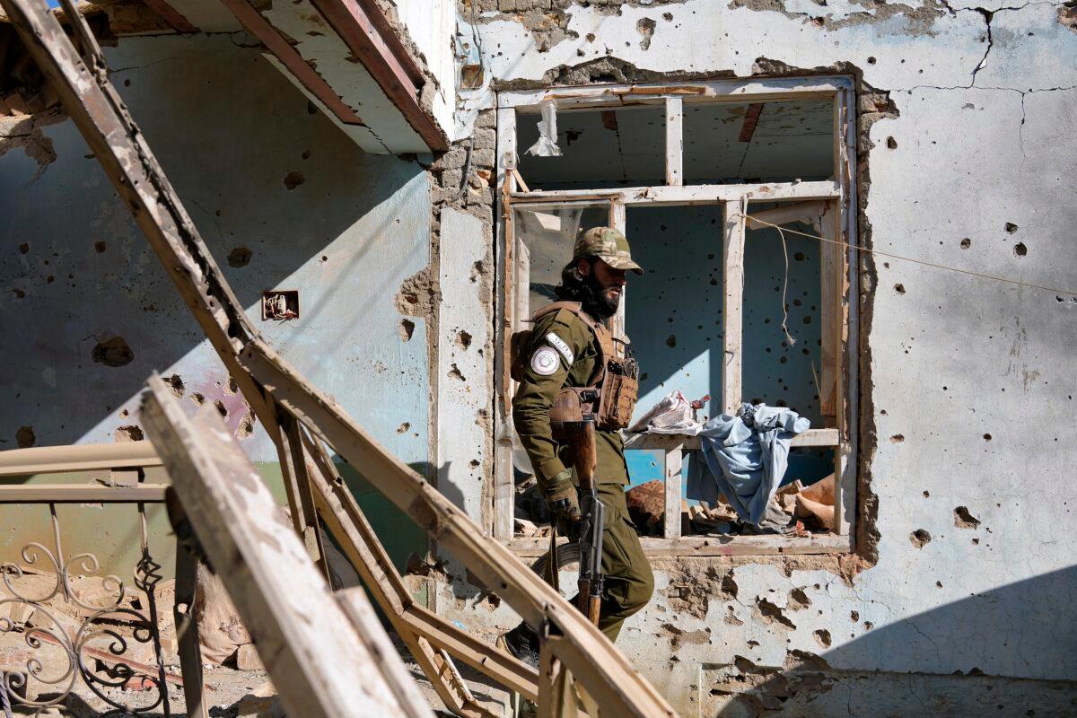 A Taliban terrorist checks an ISIS group house that was destroyed in the ongoing conflict between the two in Kabul, Afghanistan, on Jan. 5, 2023. (Ebrahim Noroozi/AP Photo)