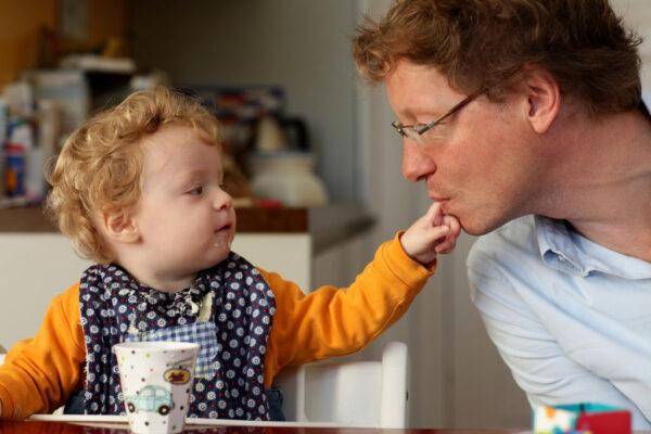 A father plays with one of his daughters during breakfast at his home in Berlin, Germany, on Aug. 31, 2010. (Sean Gallup/Getty Images)