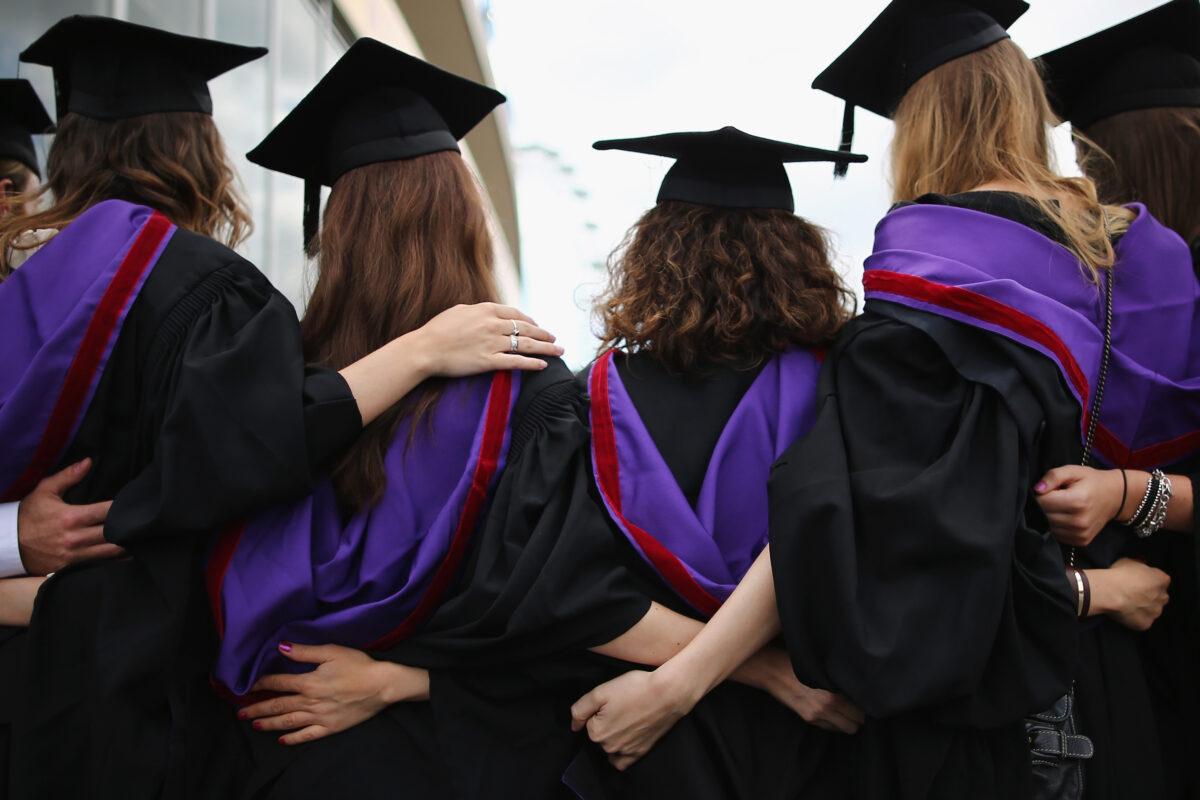 Students and family pose for photographs ahead of their graduation ceremony at the Royal Festival Hall in London on July 15, 2014. (Dan Kitwood/Getty Images)