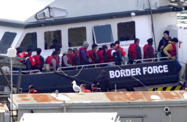 A group of illegal immigrants is brought by a Border Force vessel to Dover, Kent, on July 18, 2023. (Gareth Fuller/PA Media)