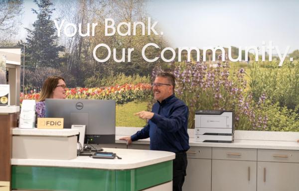 CEO Derrik Wynkoop talks with an employee at Walden Savings Bank in Montgomery, N.Y., on July 18, 2023. (Cara Ding/The Epoch Times)