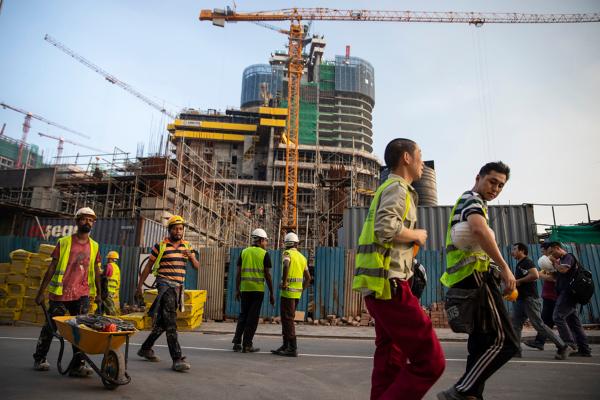 Construction workers walk on the grounds of what would become the Chinese-managed Shangri-La retail and office complex in Colombo, Sri Lanka, on Nov. 10, 2018. (Paula Bronstein/Getty Images)