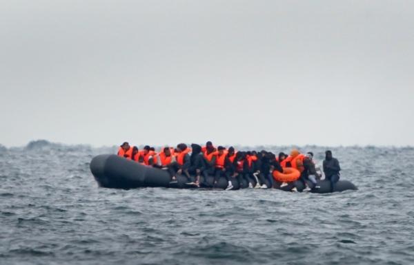 A group of people, thought to be migrants, crossing the Channel in a small boat travelling from the coast of France and heading in the direction of Dover, Kent on Aug. 29, 2023. (PA Media)