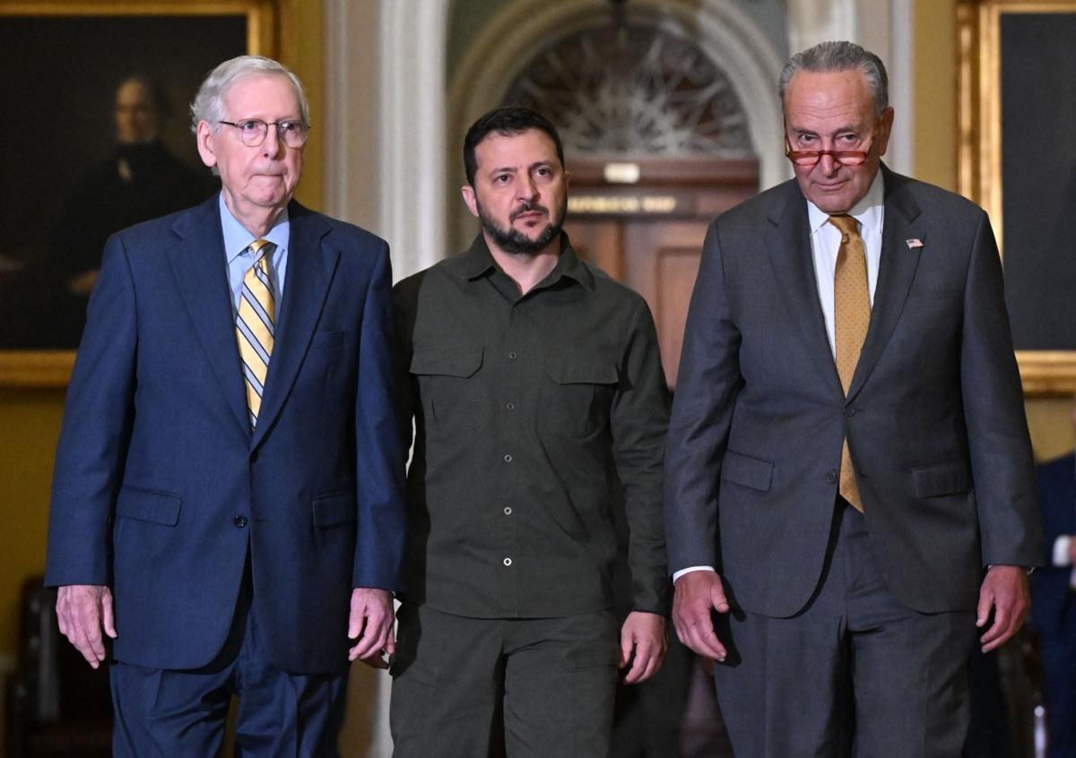 (L–R) Senate Minority Leader Mitch McConnell (R-Ky.), Ukrainian President Volodymyr Zelensky, and Senate Majority Leader Chuck Schumer (D-N.Y.) arrive to meet with senators in the Old Senate Chamber in Washington on Sept. 21, 2023. (Pedro Ugarte/AFP/Getty Images)