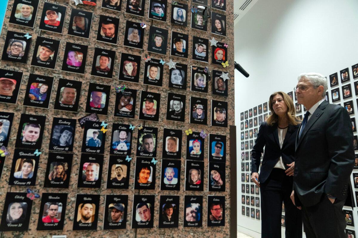 Attorney General Merrick Garland, accompanied by Anne Milgram, head of the Drug Enforcement Administration, looks at photographs of people who had died from drugs during the Second Annual Family Summit on Fentanyl at the Drug Enforcement Administration headquarters on Sept. 26, 2023. (Jose Luis Magana/AP Photo)