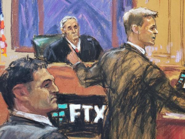 In this courtroom sketch, Sam Bankman-Fried watches as defense lawyer Mark Cohen makes his opening remarks in Mr. Bankman-Fried's fraud trial over the collapse of FTX, at Federal Court in New York, on Oct. 4, 2023. (Jane Rosenberg/Reuters)