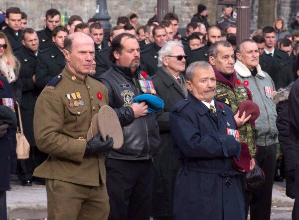 Veterans remove their hats during prayer at a Remembrance Day ceremony in Quebec City on Nov. 11, 2016. (The Canadian Press/Jacques Boissinot)