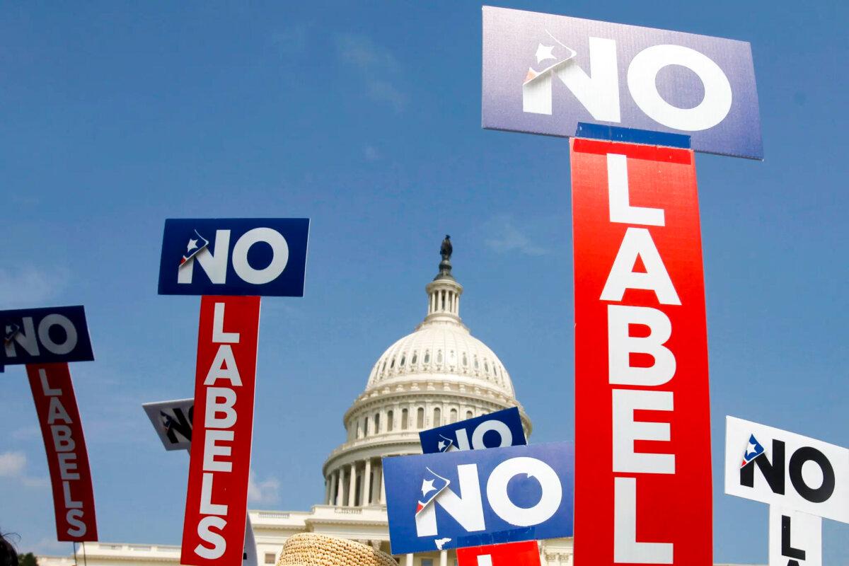 People with the group No Labels hold signs during a rally on Capitol Hill in Washington, on July 18, 2011. More than 15,000 people in Arizona have registered to join a new political party floating a possible bipartisan “unity ticket” against Joe Biden and Donald Trump. (AP Photo/Jacquelyn Martin, File)