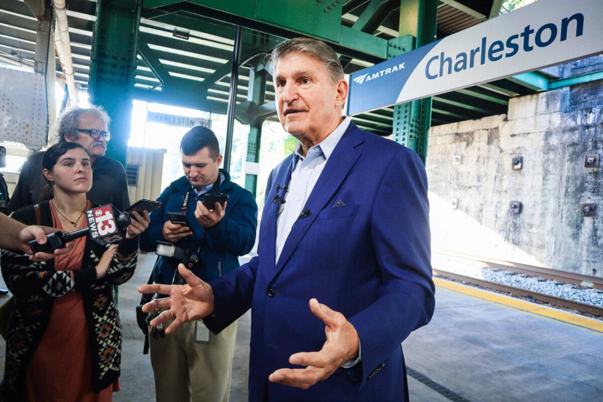 West Virginia Democrat Sen. Joe Manchin speaks with reporters outside the newly renovated Amtrak train station in Charleston, W.Va., on Oct. 12, 2023. (AP Photo/Leah Willingham)