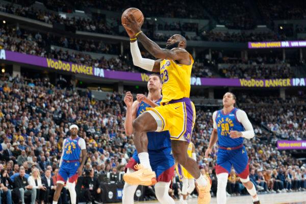 Los Angeles Lakers forward LeBron James drives to the basket past Denver Nuggets center Nikola Jokic and forward Aaron Gordon (R) during the first half of an NBA basketball game in Denver on Oct. 24, 2023. (David Zalubowski/AP Photo)