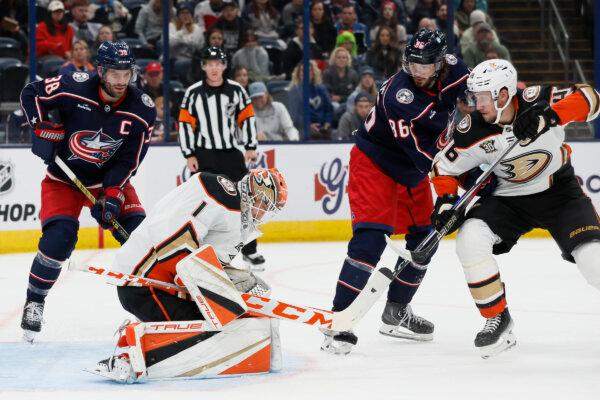Anaheim Ducks' Lukas Dostal (1) makes a save as teammate Ilya Lyubushkin (R) and Columbus Blue Jackets' Boone Jenner (L) and Kirill Marchenko look for a rebound during the second period of an NHL hockey game in Columbus, Ohio, on Oct. 24, 2023. (Jay LaPrete/AP Photo)
