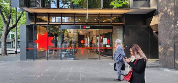 People walk past a National Australia Bank branch in Melbourne, Victoria, Australia, on Oct. 27, 2023. (Susan Mortimer/The Epoch Times)