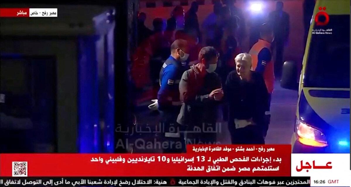 Released hostages disembark from vehicles amid a hostages-prisoners swap deal between Hamas and Israel, in Egypt, on Nov. 24, 2023. (Al Qahera News/Reuters TV via Reuters)