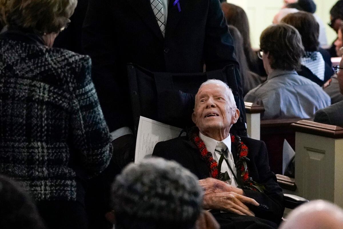 Former President Jimmy Carter greets people as he departs after the funeral service for former First Lady Rosalynn Carter at Maranatha Baptist Church in Plains, Ga., on Nov. 29, 2023. (Alex Brandon/Pool via AP Photo)