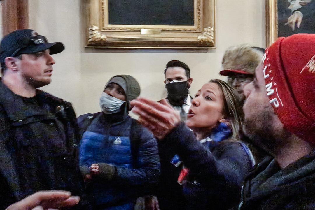 Moments before being fatally shot, Ashli Babbitt confronts three police officers for not stopping the vandalism outside the U.S. House. (Tayler Hansen/Screenshot via The Epoch Times)