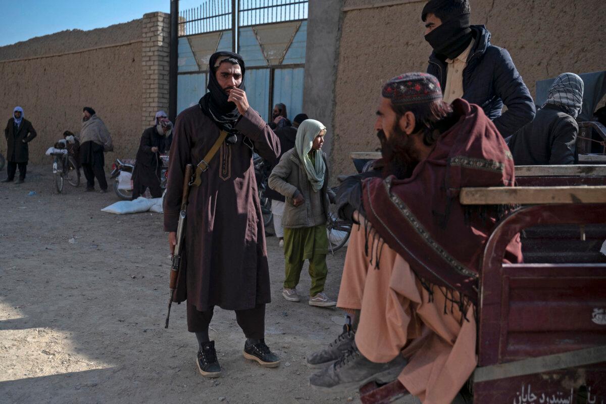 Taliban stand guard as donations from the World Food Programme are distributed at Baraki Bara, Logar Province, Afghanistan on Jan. 7, 2024. (Wakil Kohsar/AFP via Getty Images)